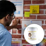 A man is organizing notes using magnets on a magnetic wall - Magnetic Plaster